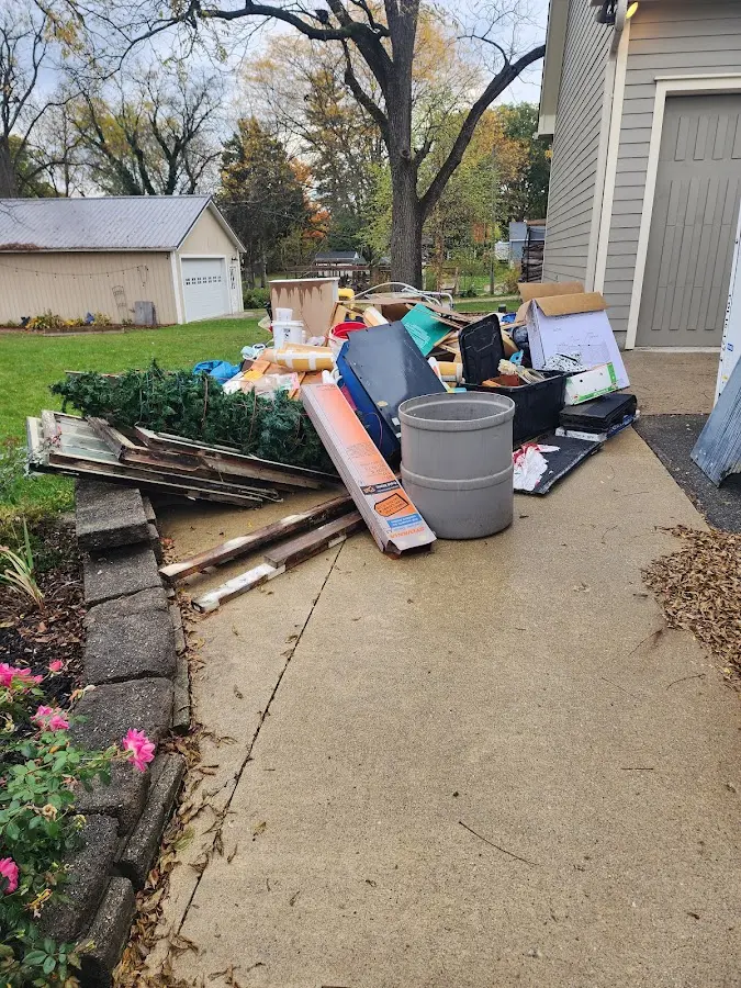 Dumpster being loaded with debris for 12 Yard Dumpster Rental in Nixa